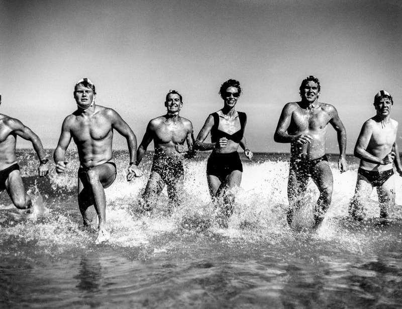 Girl Running From Surf With Lifesavers